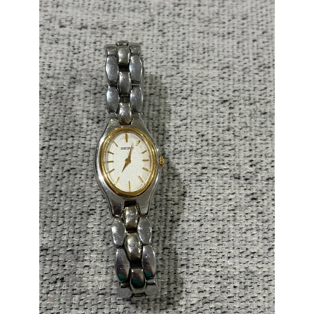 Seiko Oval Women's Two Tone Silver and Gold Wrist  Sunburst Dial Watch 1N00-6F80